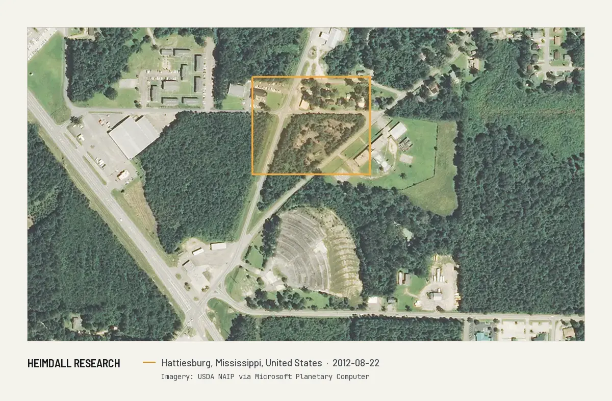 Print preview: Aerial image from August 2012 of the Beverly Drive-In Theatre site in Hattiesburg, Mississippi. The drive-in's fan-shaped parking ramps sit south of an outlined area of woods, which is where the historic register places the theater.