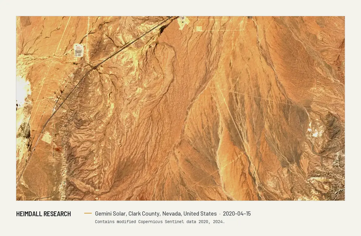 Print preview: Satellite image from April 2020 of open desert northeast of Las Vegas, with washes, a highway and a small settlement, before the solar plant was built.